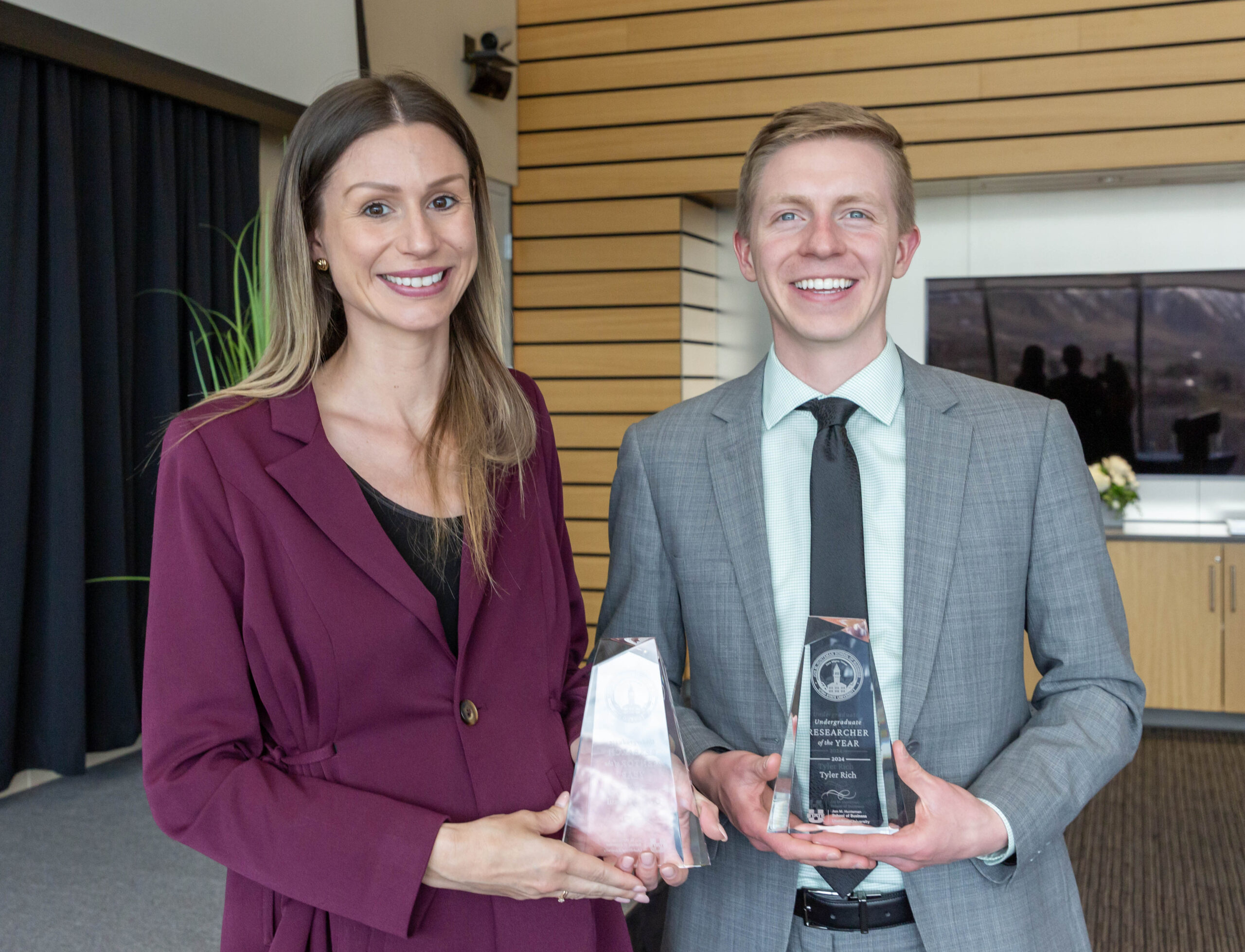 USU Professor Antje Graul received the  Faculty Undergraduate Research Mentor of the Year award from the Jon M. Huntsman School of Business. She stands with her student, Tyler Rich, while they hold their awards following the faculty awards ceremony in Logan, Utah.