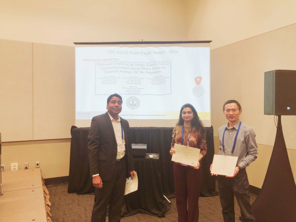 Marium Rasheed, Craig Simpson, Hongjie Wang, and Regan Zane (not pictured) at the October 2024 IEEE ECCE conference receiving the 2024 IEEE IAS Transporation Systems Committe (TSC) Second Prize Paper Award.