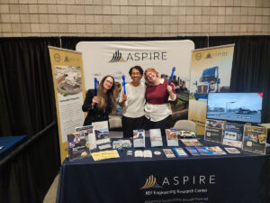 Anca Matcovschi, Fawn Groves, and Kat Web represent ASPIRE's efforts for the Utah Electrification Initiative at a tabling event as a part of the R6 Growth Summit in Richfield, Utah, on May 6, 2025.