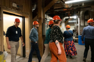 R6 Listening Tour strides out of the elevator at the IPP tour.