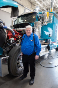 Bryce Hesterman, ASPIRE research engineer principal, posing in front of a Class 8 truck at Kenworth Sales on June 25, 2025.