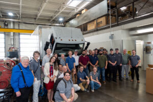 Group photo with ASPIRE students and faculty and the diesel mechanics who were training on the pictured electric Class 6 box truck, the first of its kind in Utah.