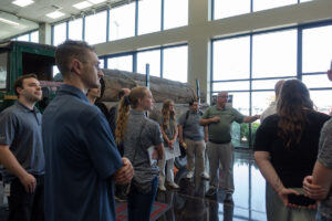 Jason Rappleye explaining the innovative growth over the years in Kenworth trucks to a group of ASPIRE students.