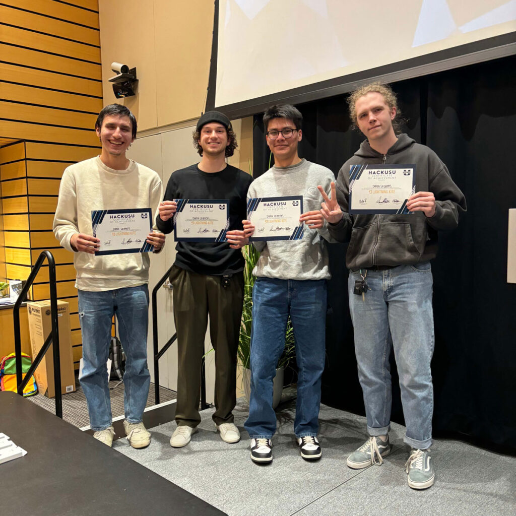 Four USU ASPIRE students receiving certificates for winning in their category at HackUSU.