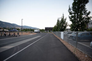 The first in-motion charging Class 6 box truck driving around the bend of the track outside the EVR.