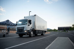 The first in-motion charging Class 6 box truck makes its way around the track outside the EVR.