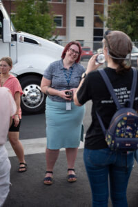 Greeting guests as they wait for a ride on the in-motion charging Class 8 electrified semi-truck.