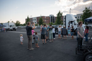 Guests wait in line for the opportunity to ride in the in-motion charging Class 8 semi truck.