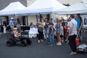 Children stand in line to ride in the remote control RealTree Cars.