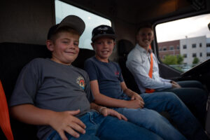 Children pose with the driver in the Class 8 Box truck.