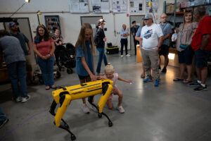 Children pet Spot, the yellow robotic dog.