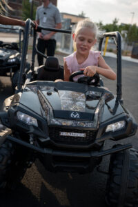Girl rides in remote-controlled RealTree car.