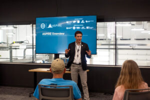 Center Director Regan Zane presents with enthusiasm at the ASPIRE Open House.