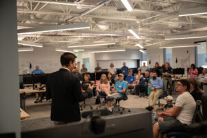 Center Director Regan Zane presents to a group of guests about ASPIRE's purpose at the Open House on July 17.