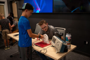Young guest spins the wheel to learn about energy generation.