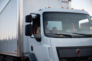 Up close view of guests riding in the fully electric box truck.