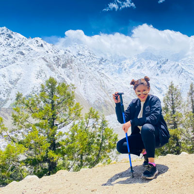 Zainab poses in front of the mountaing on a trek of Nanga Parbat (or "Naked Mountain") in the Western Himalayas, the second most prominent peak in the range after Mt. Everest and the 9th tallest in the world.