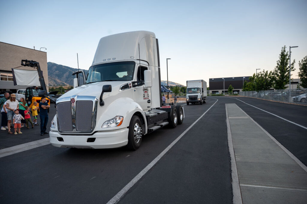 Image of the Class 6 and Class 8 electrified trucks developed with Kenworth Sales Company in front of the EVR.