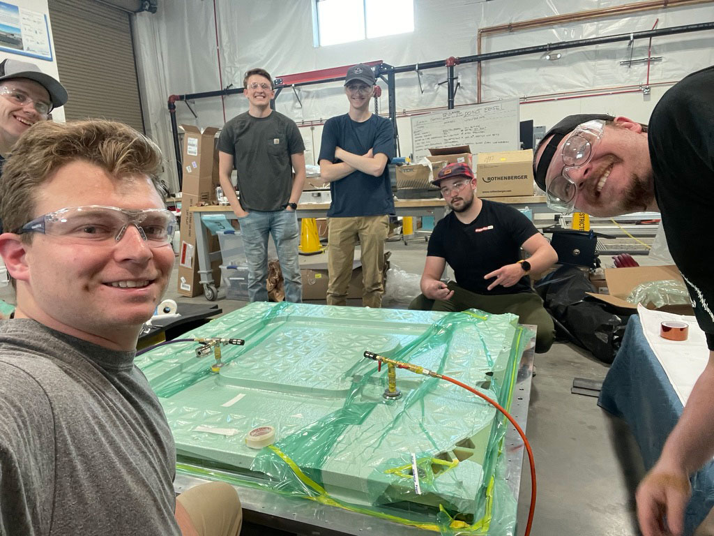 Mackay Baugh smiling with ASPIRE faculty and staff in the EVR lab.