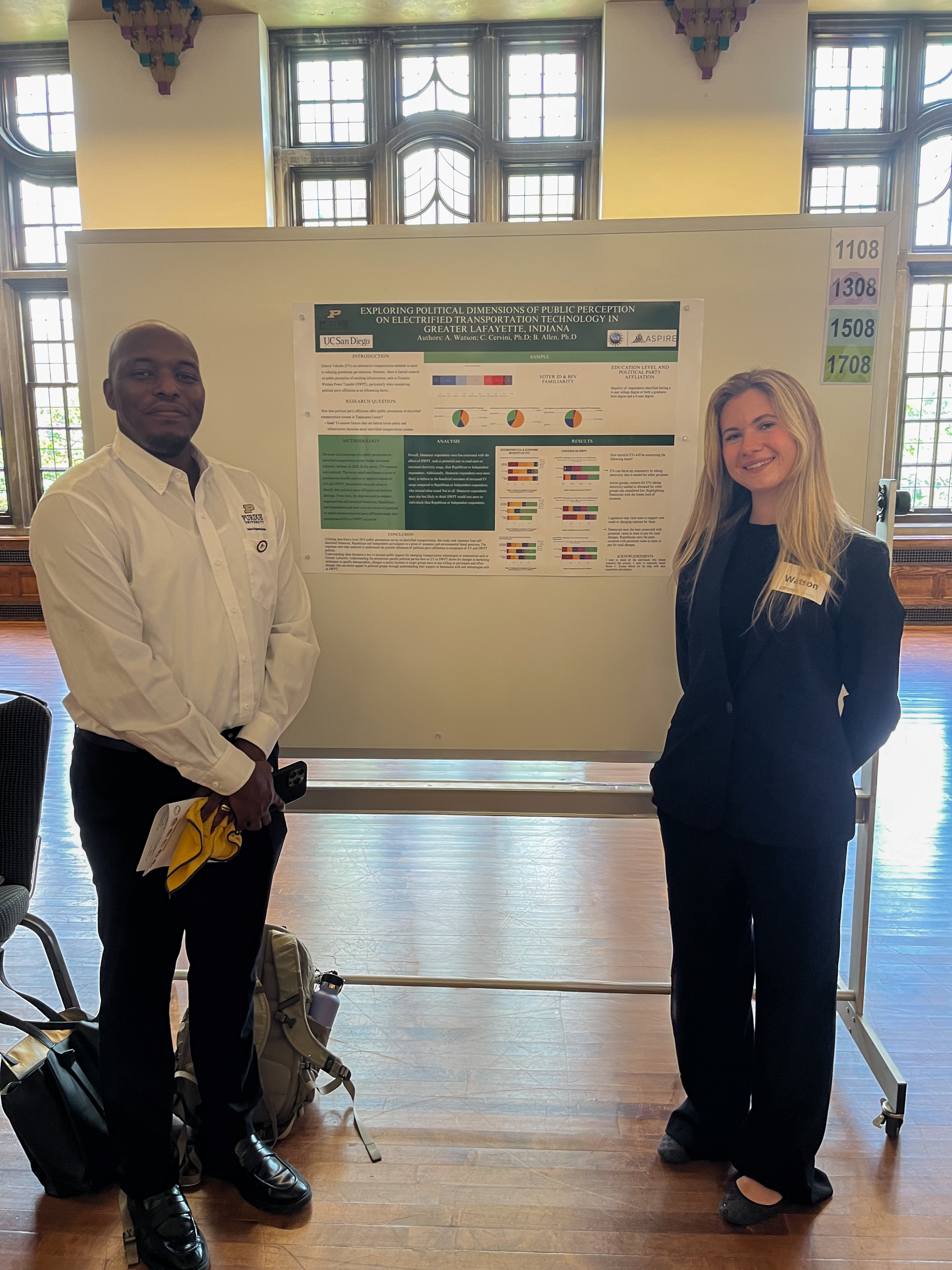 REU student Ava Watson standing next to her research poster and faculty mentor, Brandon Allen.