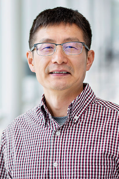 Hailei Wang smiling in front of a blurred background.