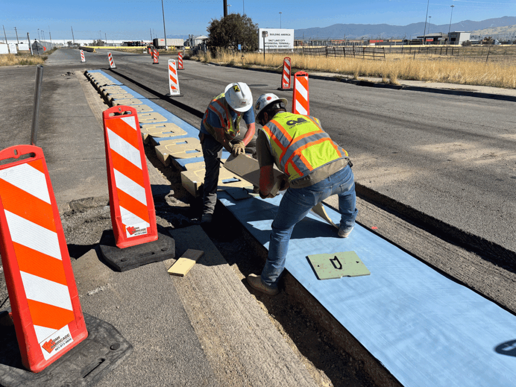 Construction workers installing the ASPIRE Electreon DWPT system at the Utah Inland Port.