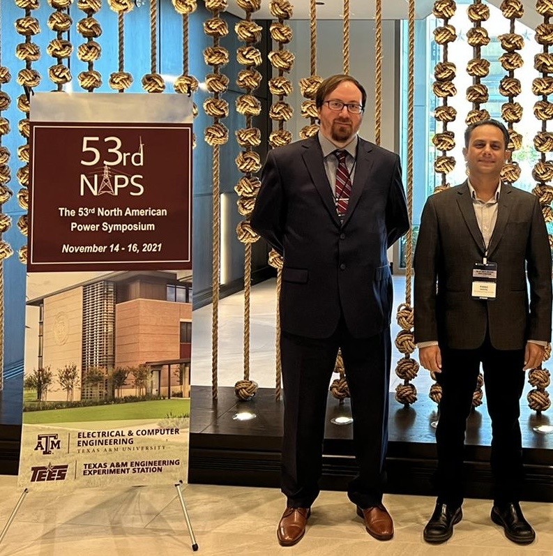 Travis Newbolt and Paras Mandal next to their poster at the conference.