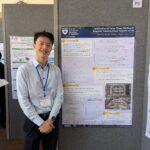 Brian Gu standing next to his research poster.