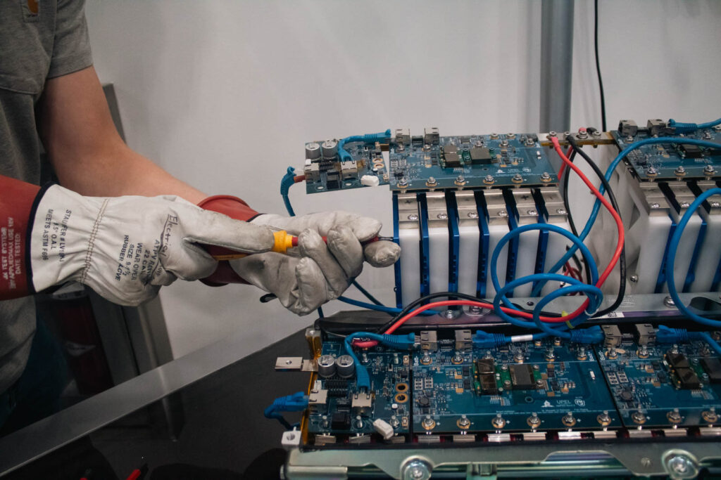 An engineer works on a battery for an electric vehicle.