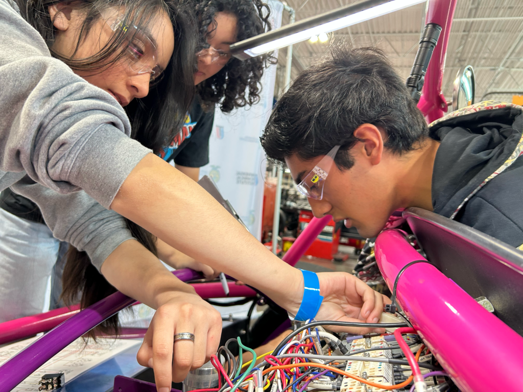 Students work on wiring for an electric vehicle from Switch Vehicles' Switch Labs program.