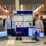 Zac Maughan with his partner showing off their poster and robot at the USU Senior Design Night.
