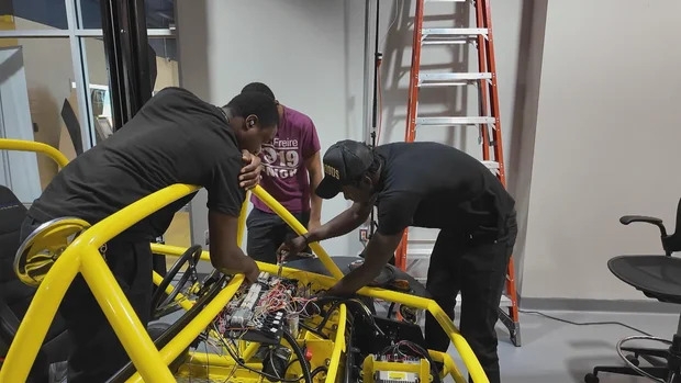 Students at the Community College of Philadelphia work on an electric vehicle from Switch Vehicles' Switch Labs program.