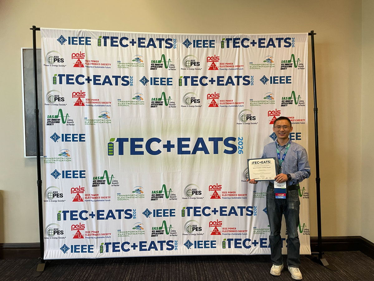 Hongjie Wang accepting the Best Paper Award on behalf of his research team.
