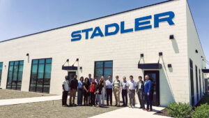 ASPIRE Student Cohort trip posing for a photo outside Stadler US.